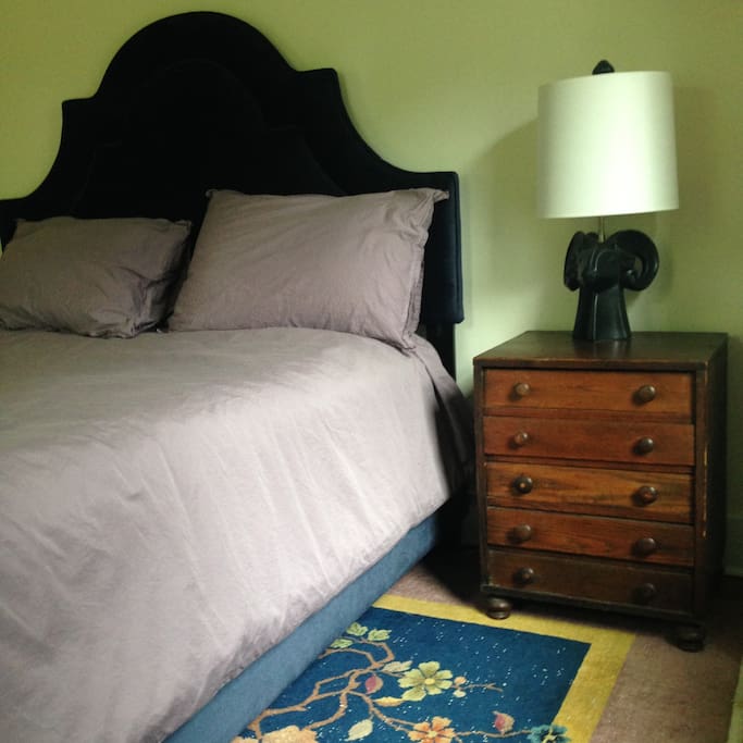 Large guest room with desk, shaded from the front yard by the hydrangeas.