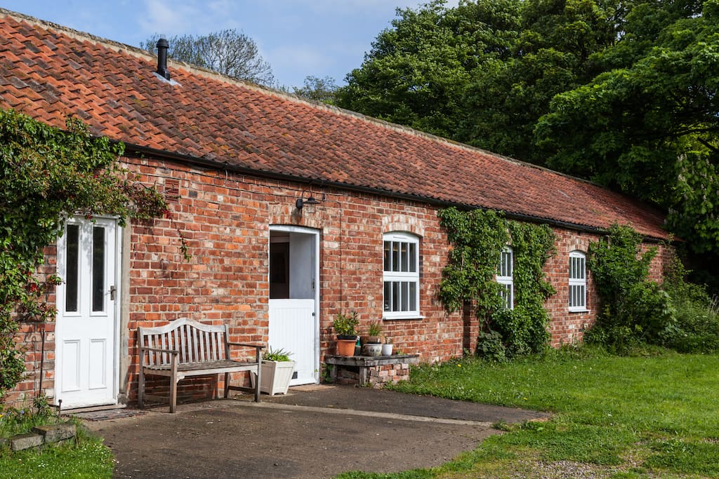 Front of cottage - stable front door and bench for enjoying the sun