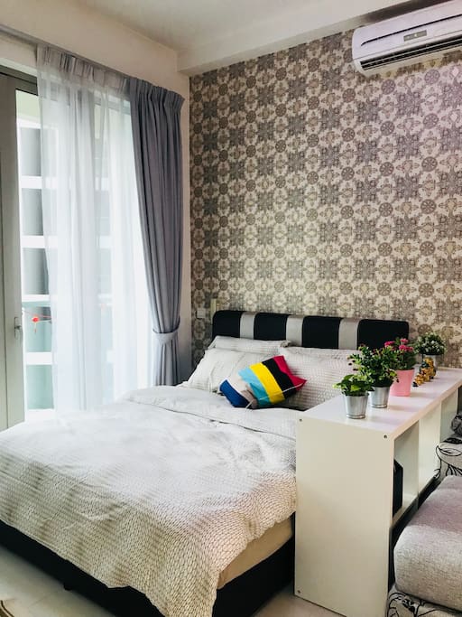 Queen sized bed in common area