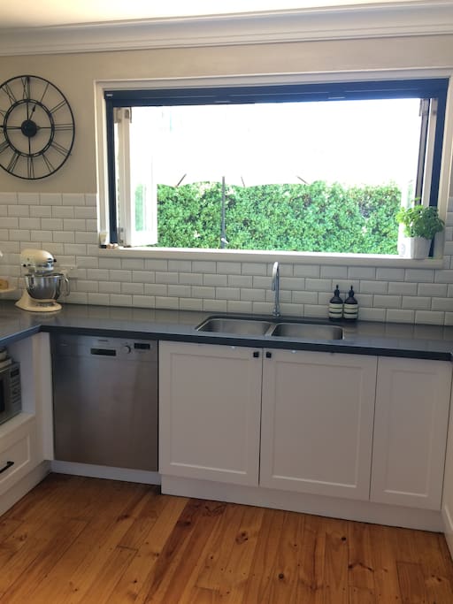 Bifold windows and doors open the kitchen onto our deck
