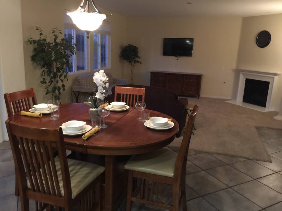 Adjustable, high seating Casual Table for up to six (6) persons. Views of the Casual Living Room, Kitchen and Back Yard. Relax in-front of a 47" flat screen TV and warm gas fire place.
