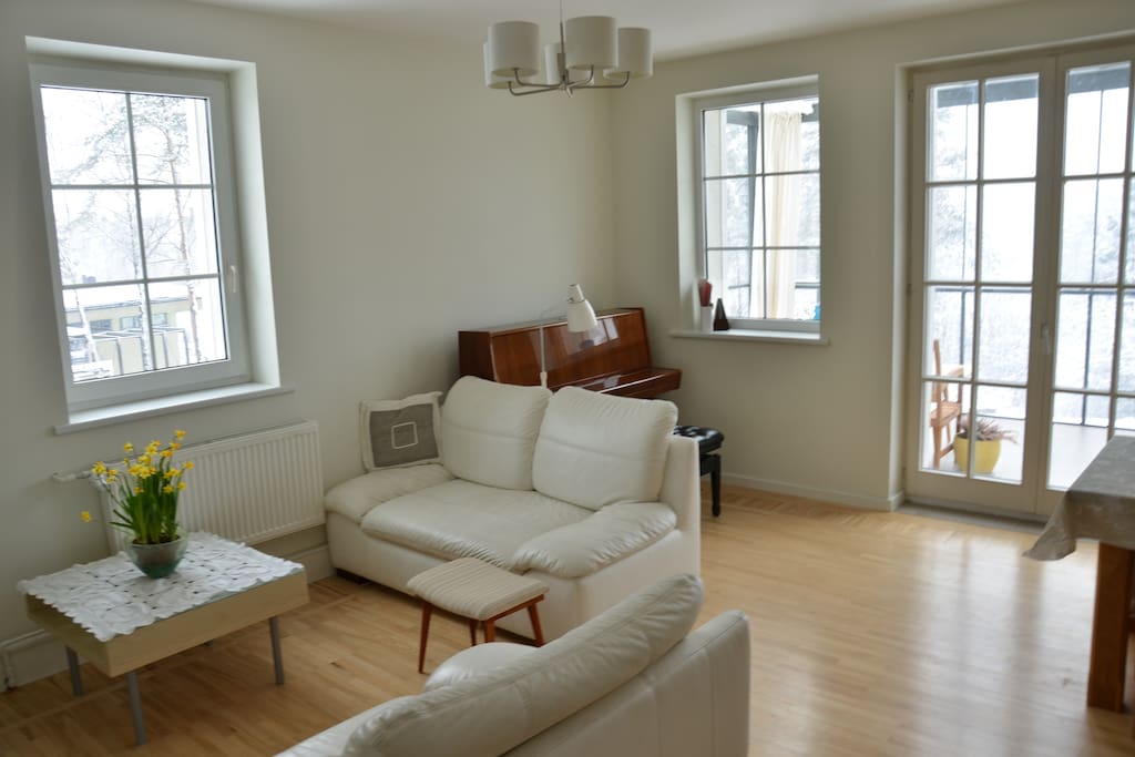 Lots of day light, white colors, natural wood floor and access to a terrace makes living room the heart of the house.