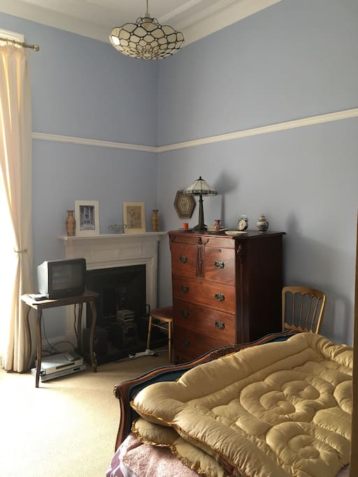 Light airy room with original antique deco furniture and ceiling cornicing.