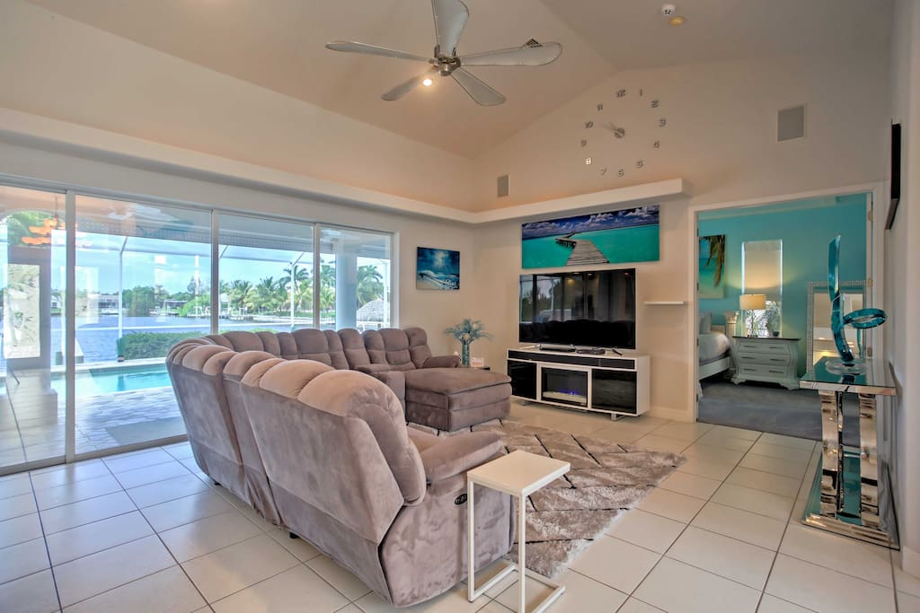 The living room includes a massive reclining sectional and a large, 75-inch flat-screen cable TV, perfect for the family to enjoy a movie together at the end of the day.