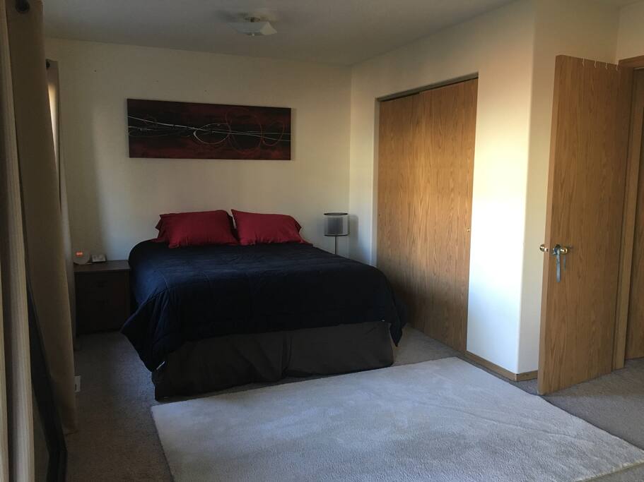 The bed side of the room with closet and entrance to the room (far right).