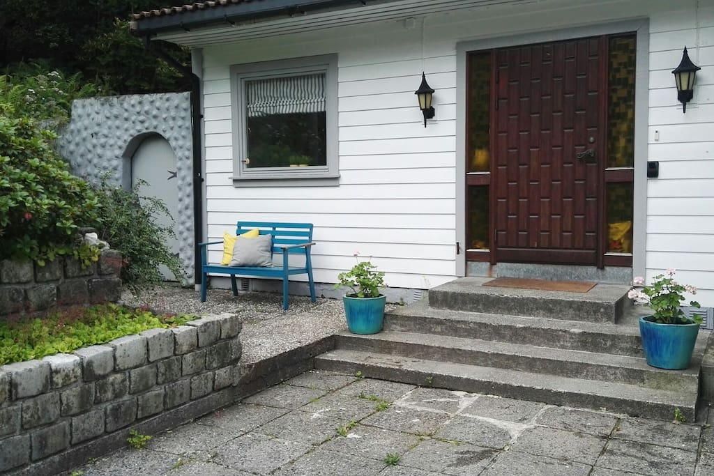 The room is behind the window to the left.