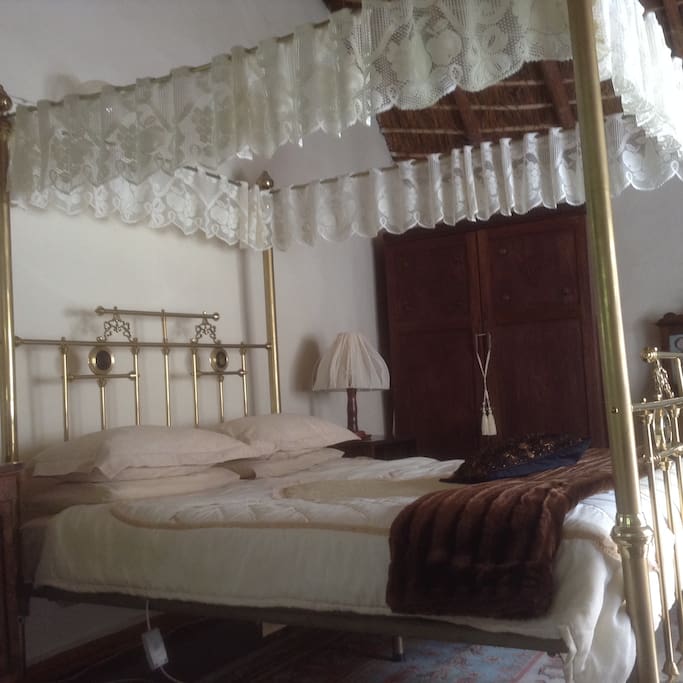 master bedroom with brass 4 poster queen size bed