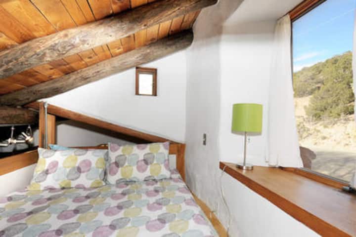 Lofted queen bed in guesthouse