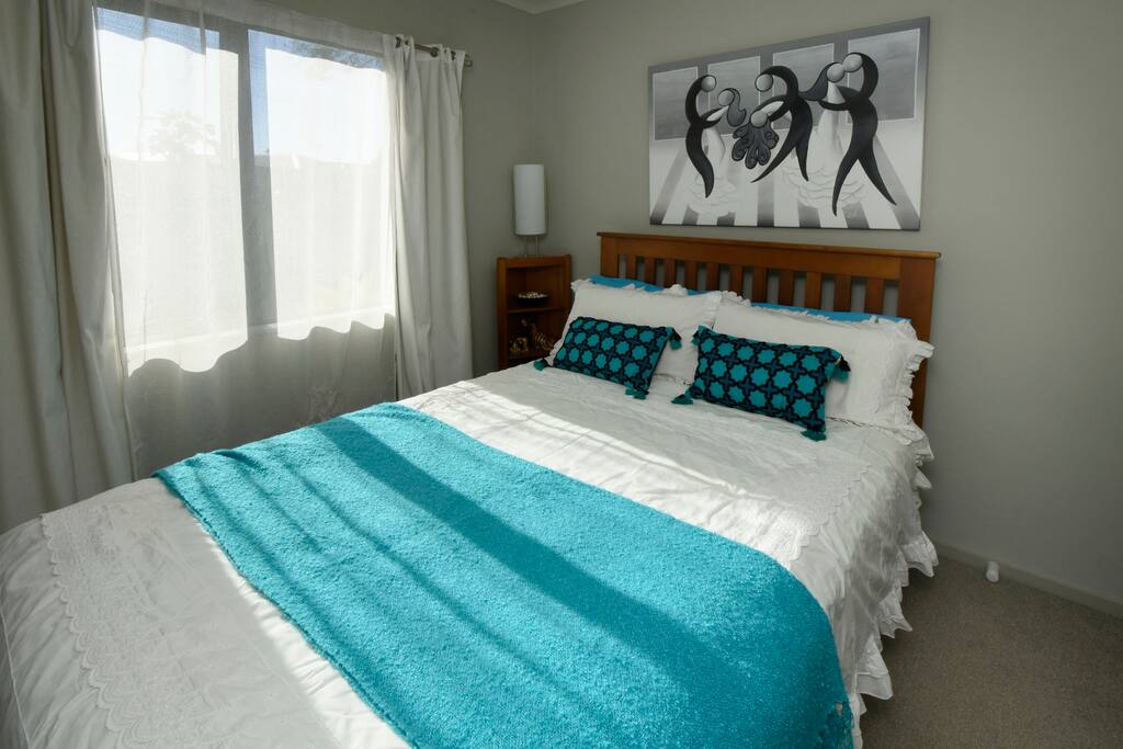 A bright airy bedroom with close access to the bathroom