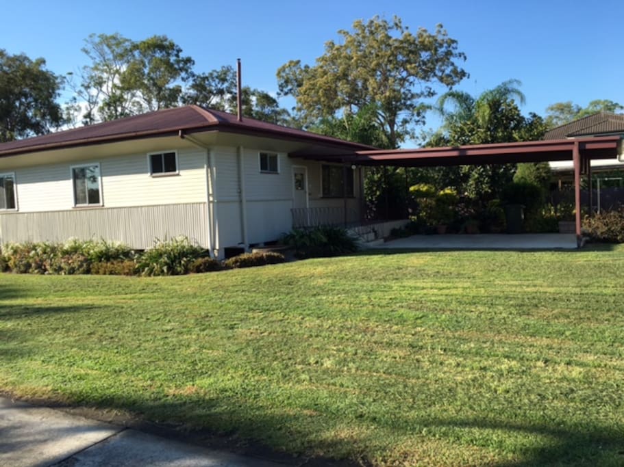 House exterior with carport for 2 vehicles - with plenty of yard for the family.