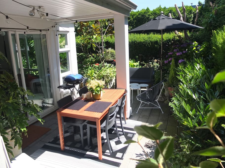 Private outdoor terrace features dining table for up to 6, sitting area for 4, BBQ and lush/private garden. There is a pathway from here that connects to a large, open shared grassy area.