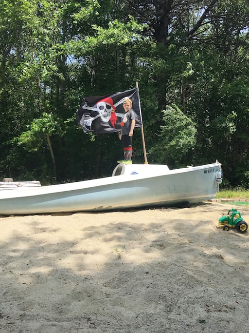 Our large sandbox for the kids has an old sailboat - perfect for playing pirates.