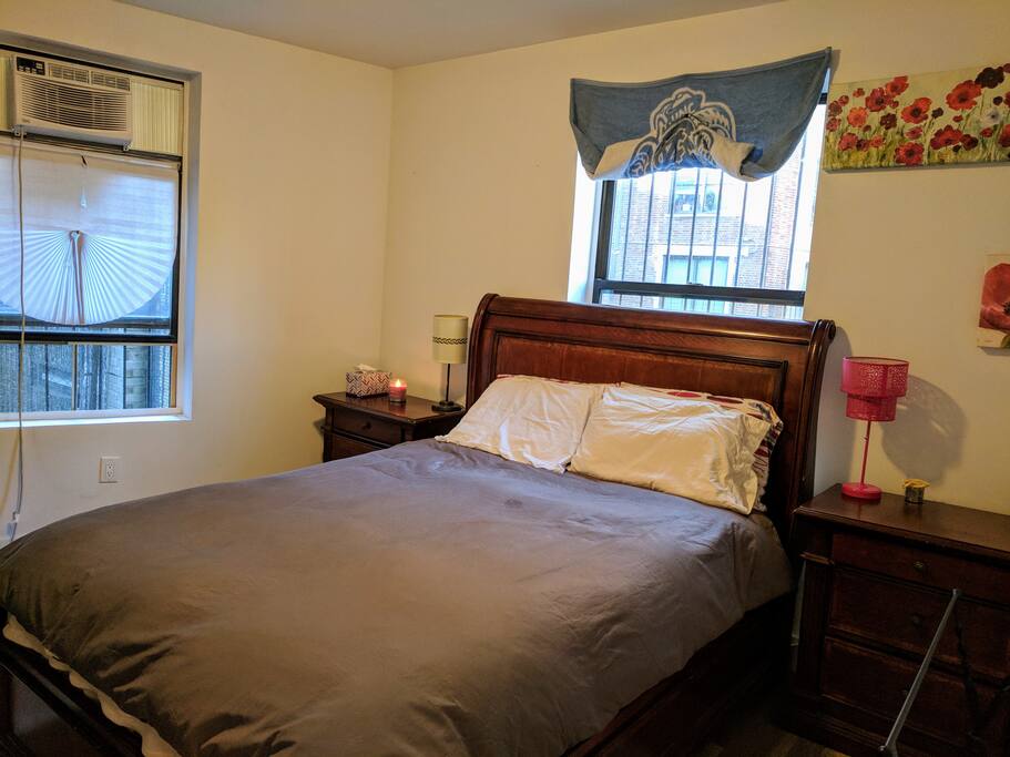 View of bedroom from the door. Beautiful furniture comfy bed, well lit space-- what more could you ask for?