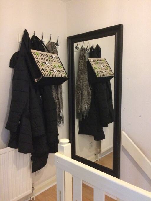 Hallway with coat rail and full length mirror.