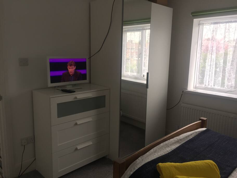 TV, mirrored wardrobe and chest of drawers