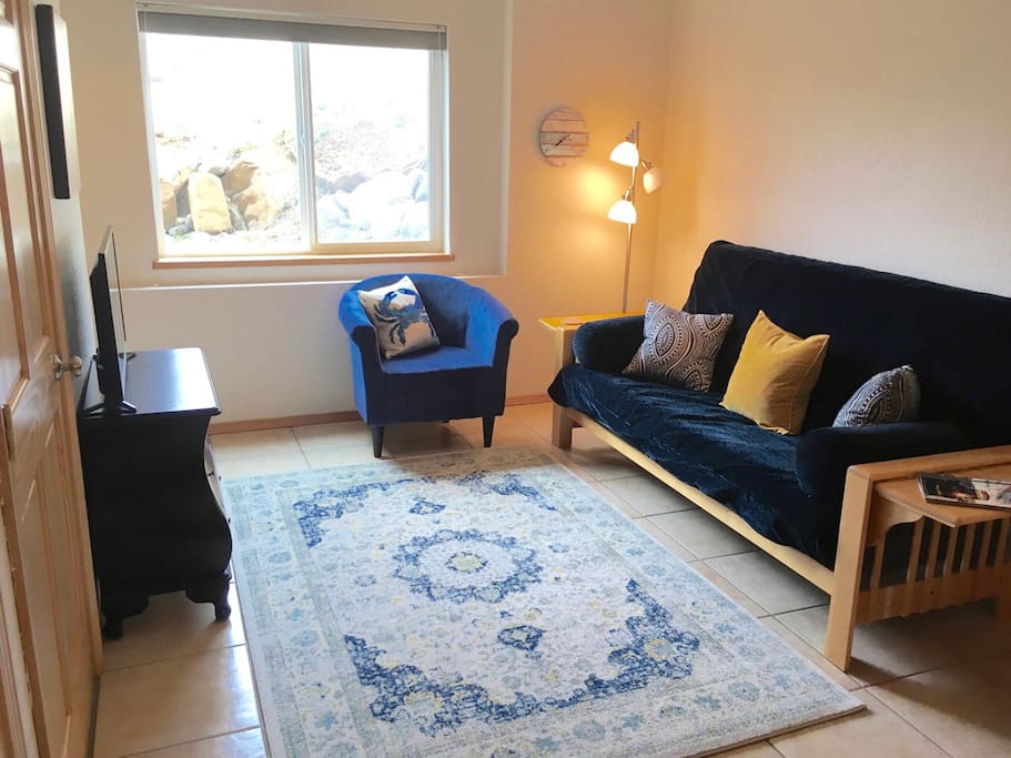 Full futon with linens and bedding.