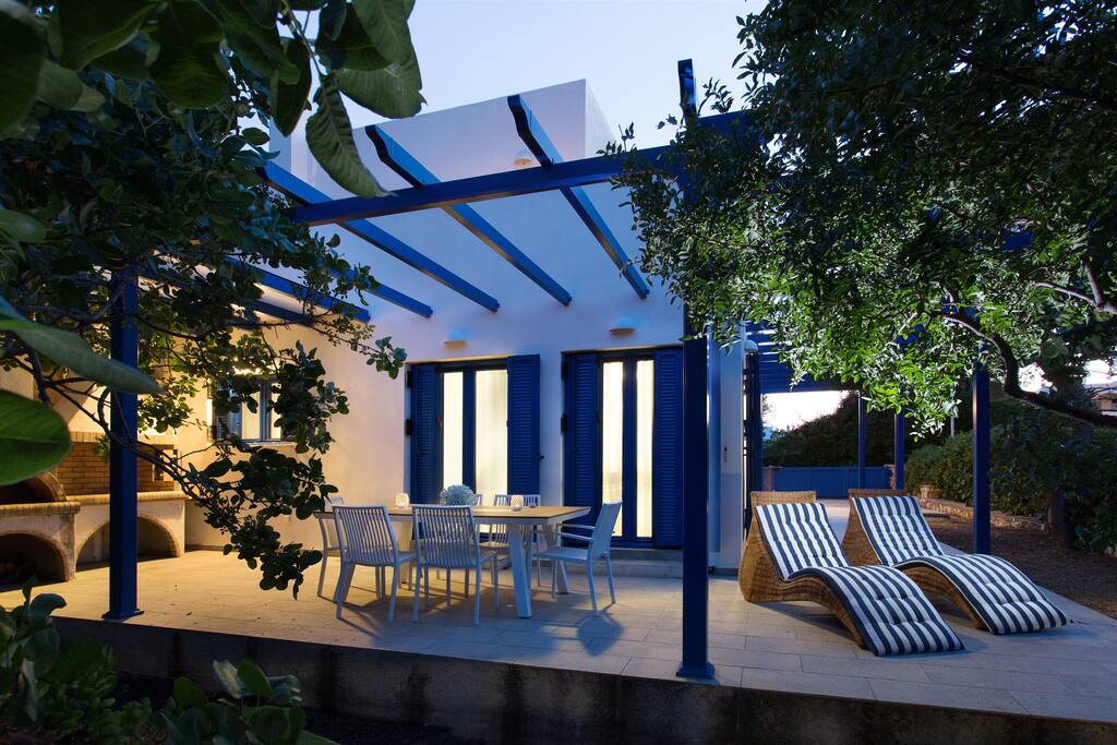Terrace with loungers and dining table
