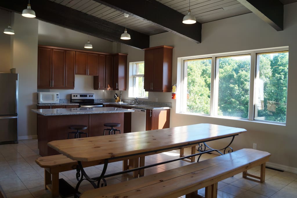 Large farmhouse table that seats 12 and extra seating at the kitchen island