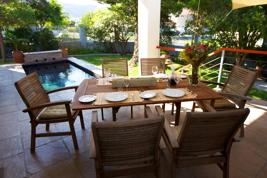 The dining area leads out to a covered braai and pool area