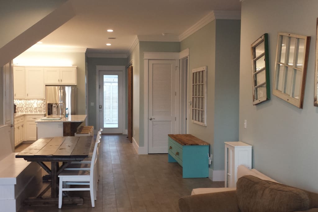 View from living room to dining room and kitchen. Bedrooms and laundry room are to the right.
