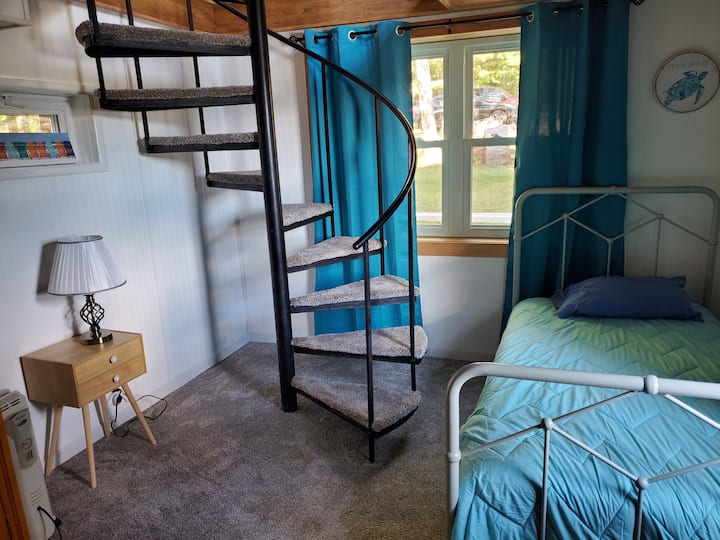 Spiral staircase to living room upstairs. Twin bedroom with a lake view 