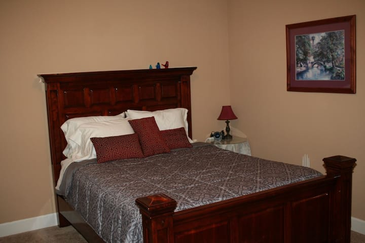 Bedroom 2, "Brown Room", Has a comfortable queen size bed, and Cane backed rocking chair.  Double closet provides ample storage.  