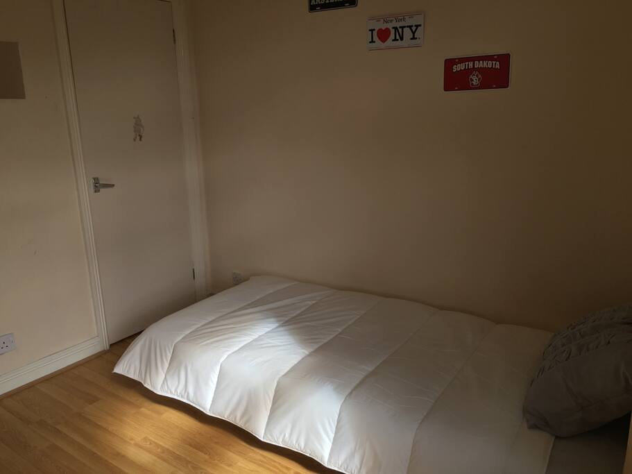 Comfy bed with a small closet.
