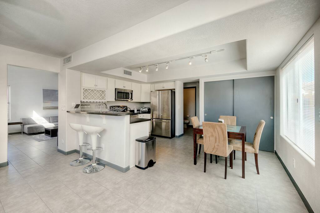 A dining table for 4 sits adjacent to the kitchen