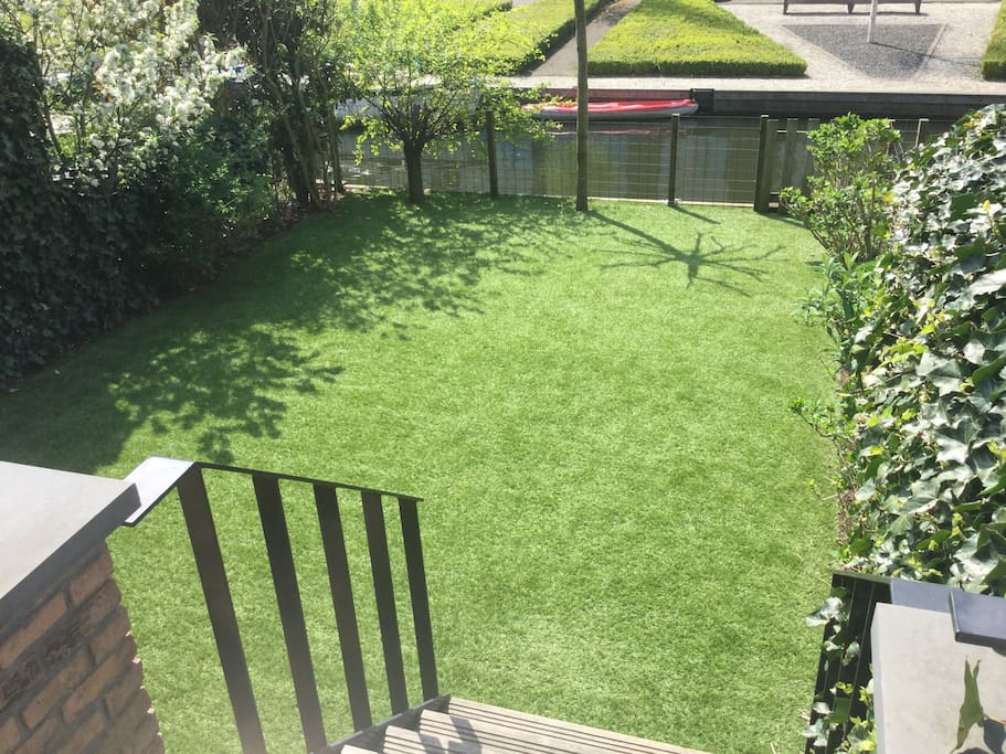 Sun , South facing garden with artificial grass for all year round use.