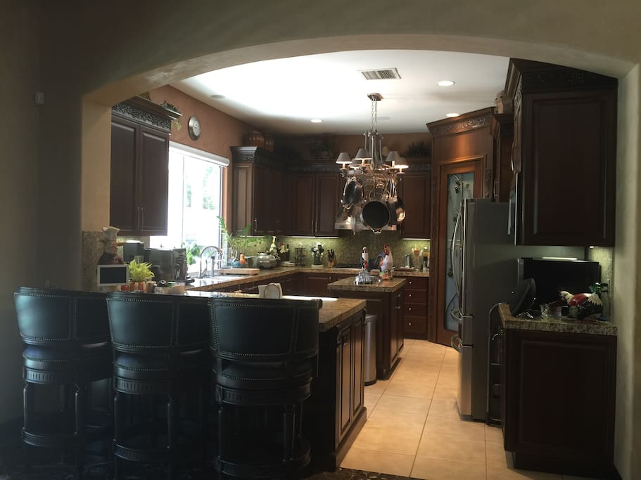 Kitchen with counter seating, new refrigerator and espresso machine
