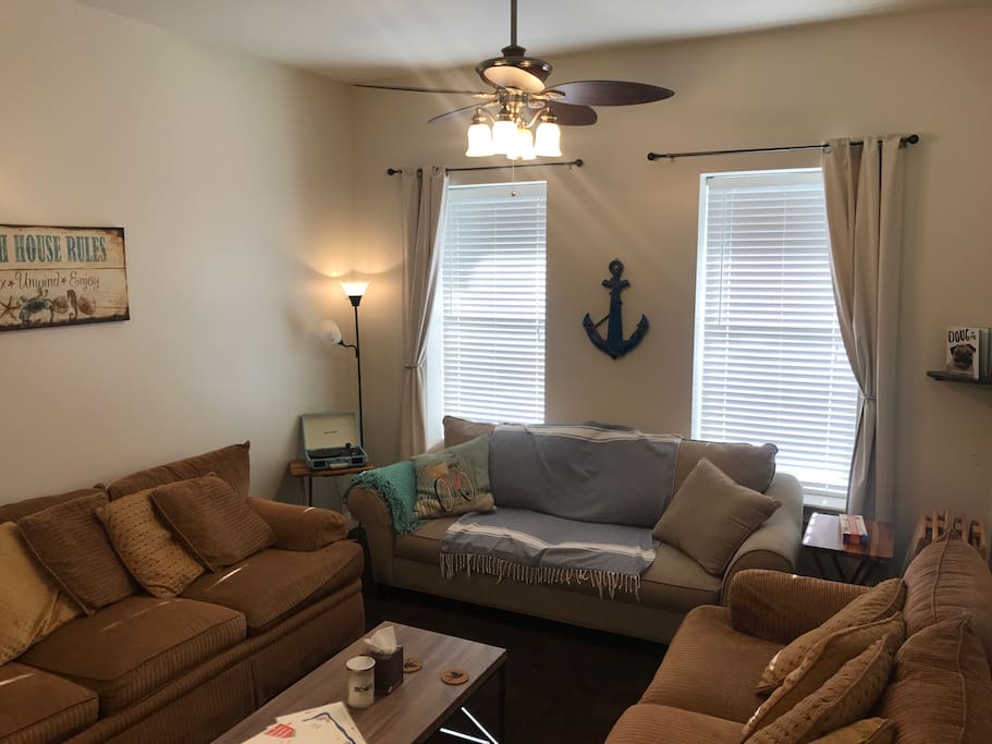 Living room is large enough to seat everyone, complete with high ceilings, 55" HD TV, Roku w/Netflix & Sling, BlueRay, Chromecast, vinyl record & bluetooth player, lamp and queen pull out sofa bed. There are also 6 wooden foldout TV tables for dinners or party hosting.