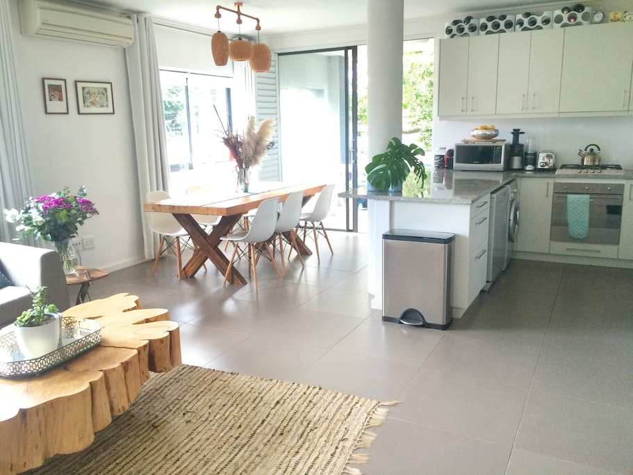 Open plan living space. Kitchen with gas stove, dish washer & washing machine.