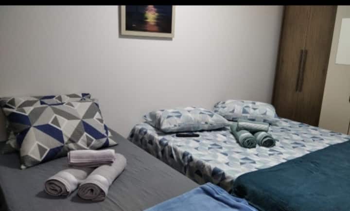 חדר עם מיטה זוגית ומיטת יחיד.