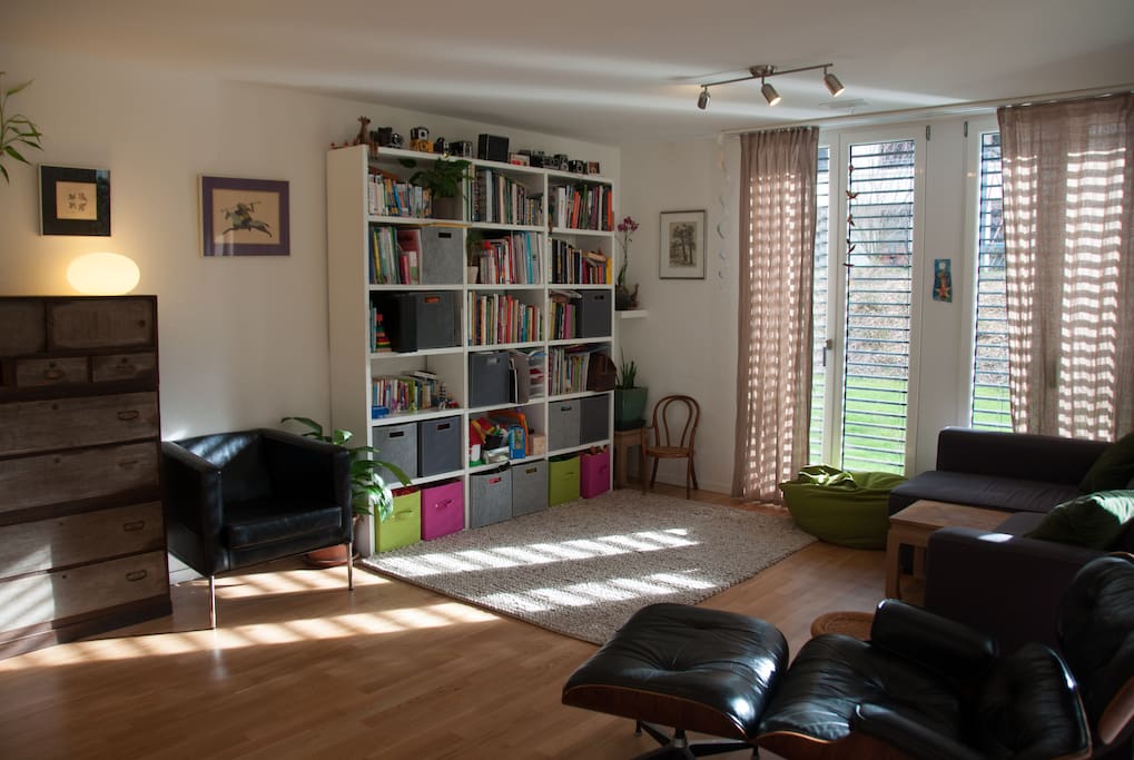 Living room with sofa and two leather chairs.