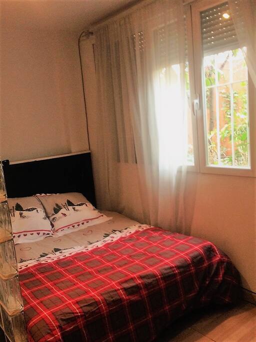 Double bed, window facing to a private garden.