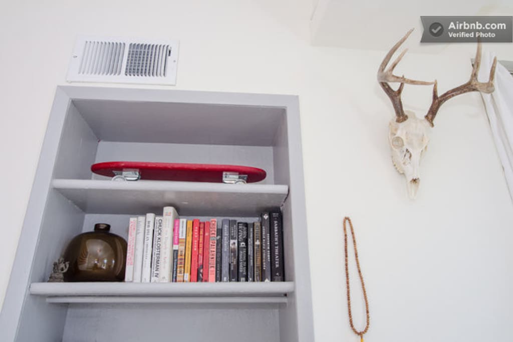 shelves with books and other cool looking things.