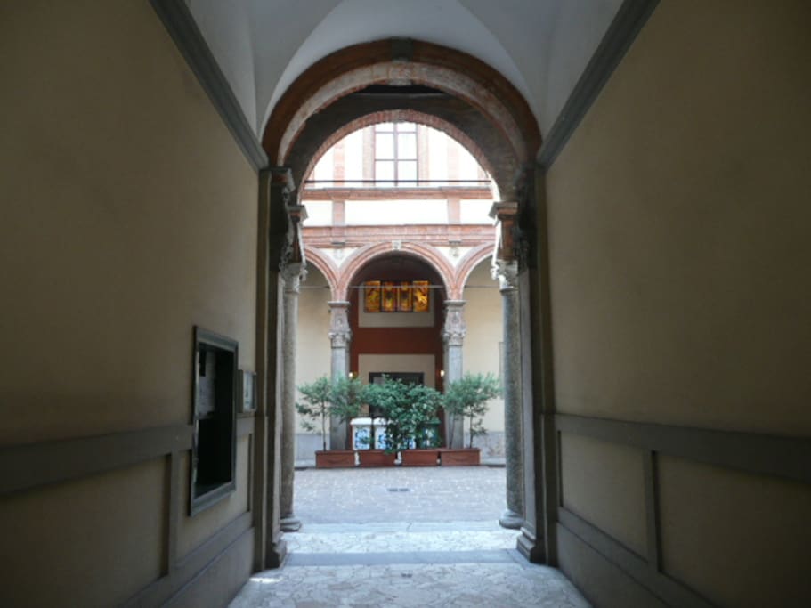 Main gate building entrance to Bramante's Renaissance courtyard with Green (glass) Brown (organic) and White (paper) differentiated garbage collection (Yellow (metal & plastic) and Gray (medical, condoms, tampax etc.) in staircase C basement