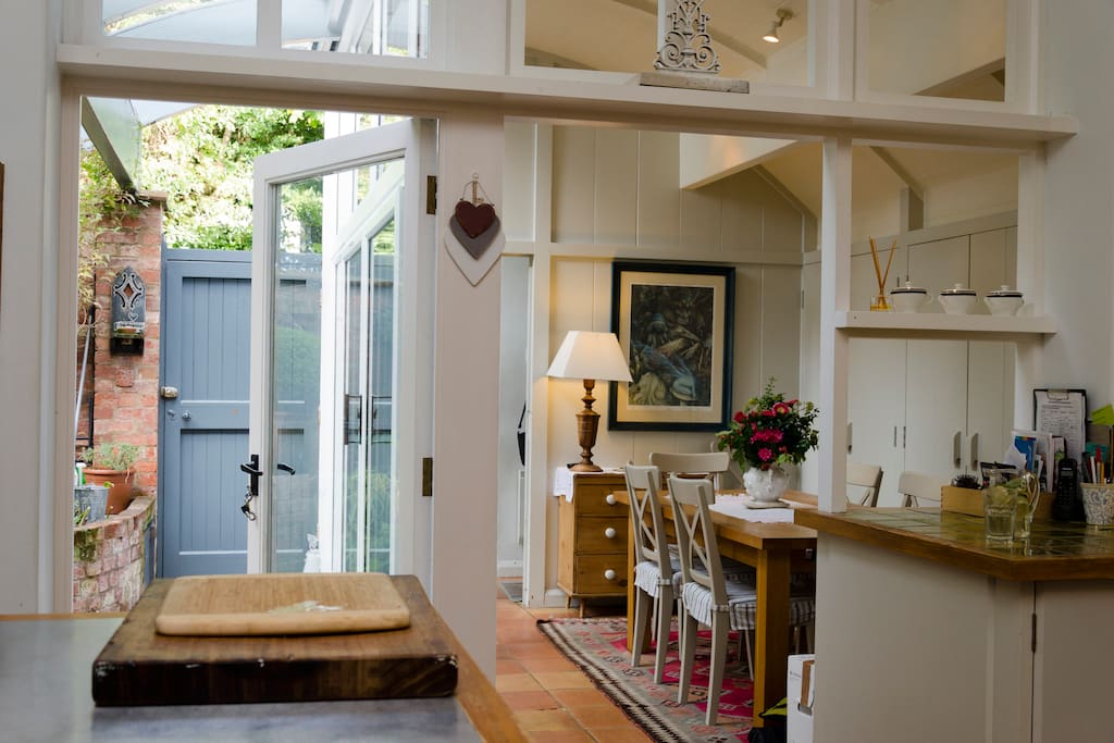 Breakfast room off the kitchen with light streaming in from wall of glass.