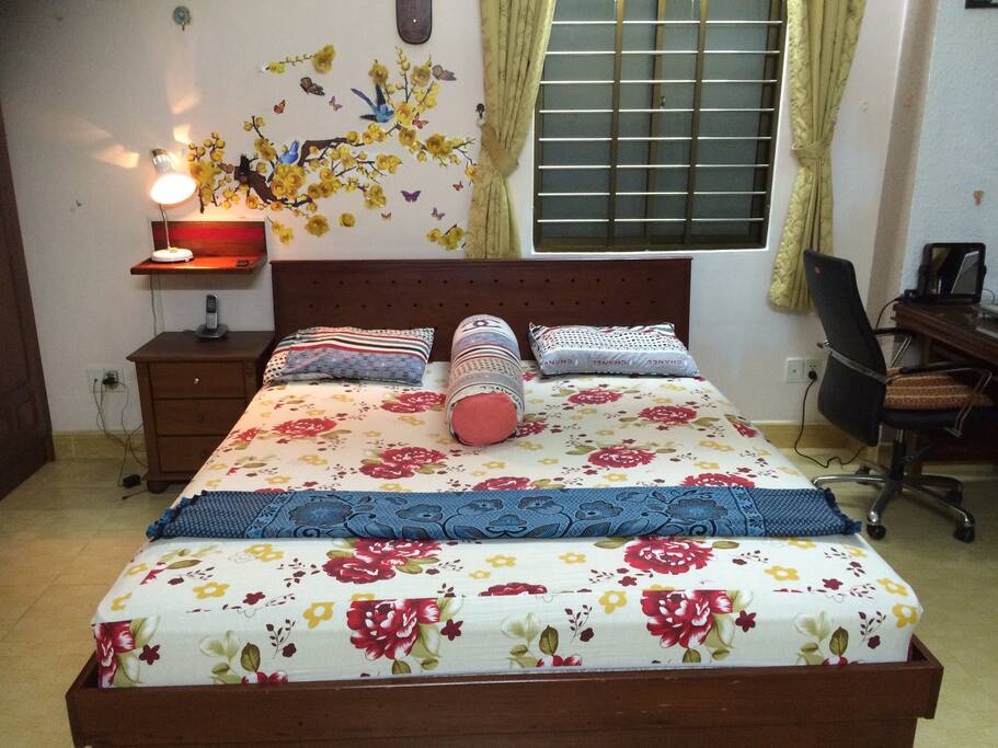 Wooden double bed and cabinet in front of bed