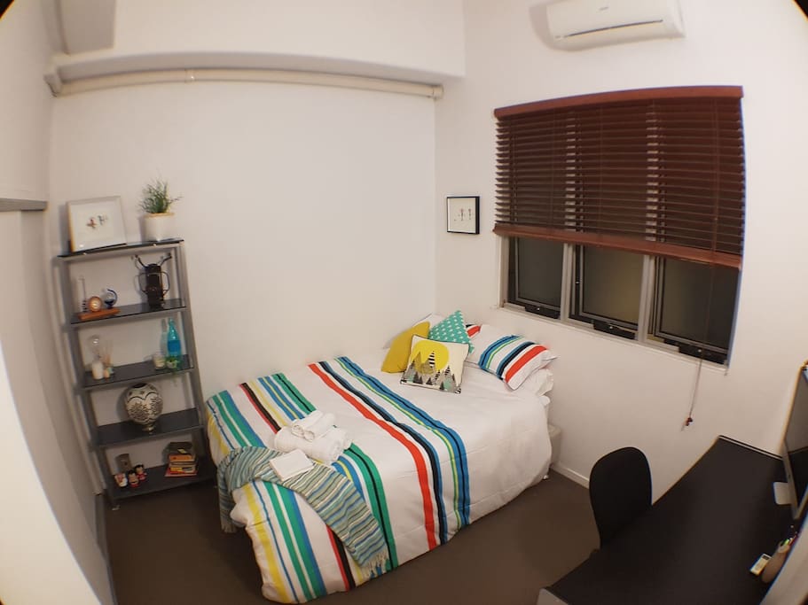 Bedroom with built in robe, air con, queen bed with fresh linen, draws, desk and chair, unlimited wifi, internal facing, ottoman, pedestal fan