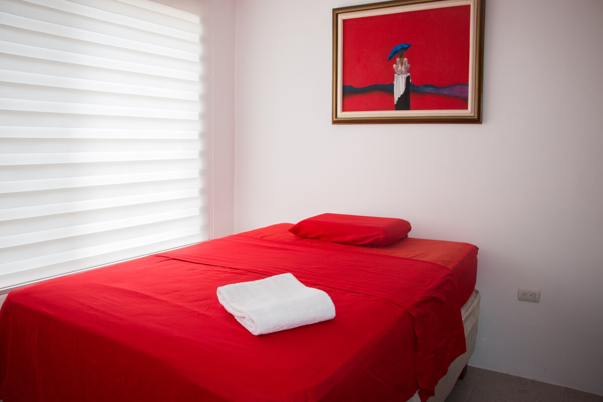 Master bedroom with double bed and private bathroom. 