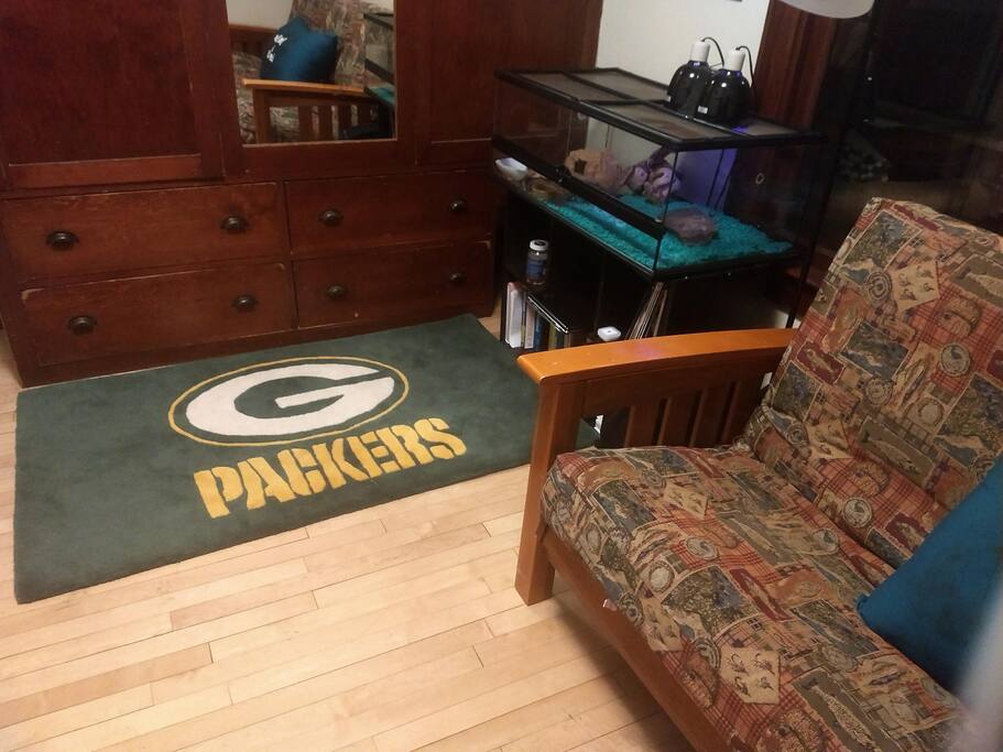 small room with some storage for personal iteams, queen sized pull out futon, rocking chair and lovely view to our drive way