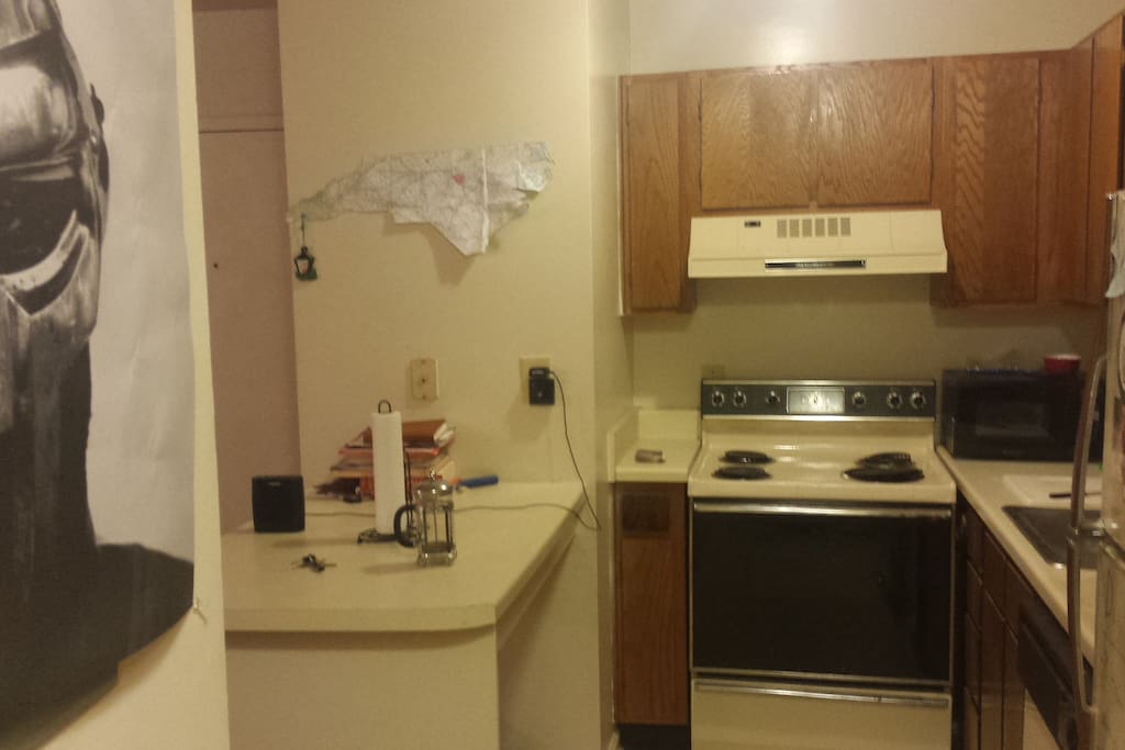 Kitchen includes oven/stove, microwave, panini press, and fridge/freezer