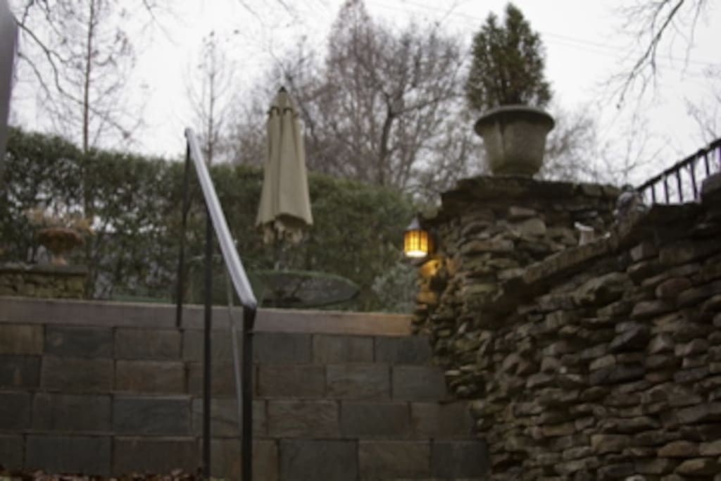 Outdoor patio with grill at entrance to downstairs apartment.