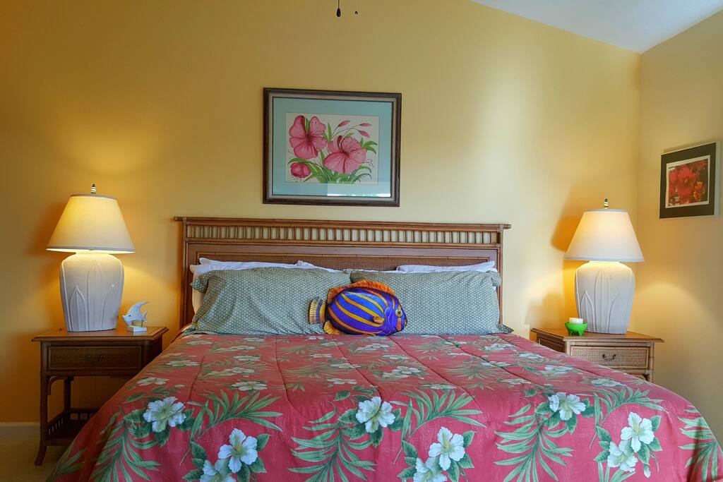 Master bedroom with new bedding, fluffy pillows and large balcony