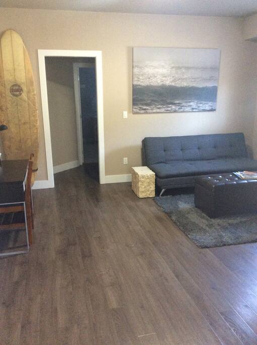Living room with office space and a couch that can pull out to a double bed.