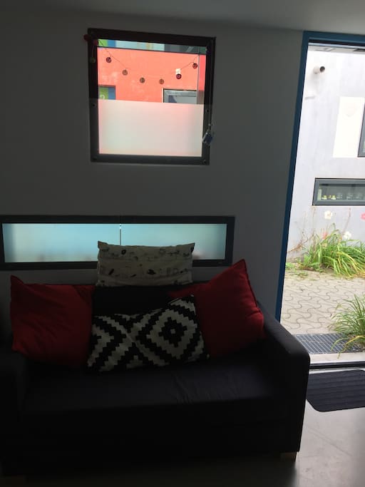 The view from the kitchen to the futon and out the front door