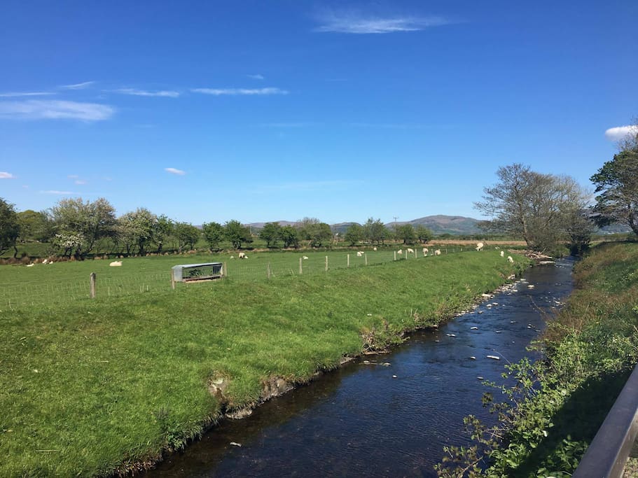 The view from the rear of the property . The Black Beck runs alongside the back of the cottage .