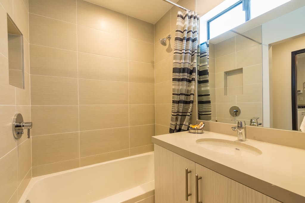 Full size bathroom with tub and shower.