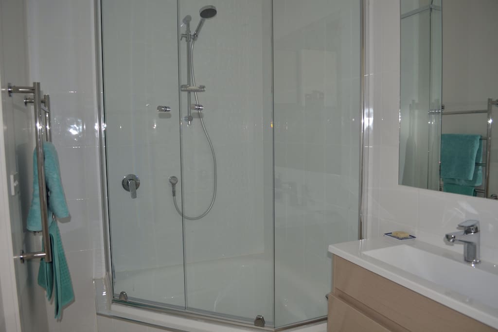 Your bathroom with small corner bath, toilet and heated towel rail.